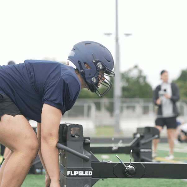 Football Players Training With FlipSled